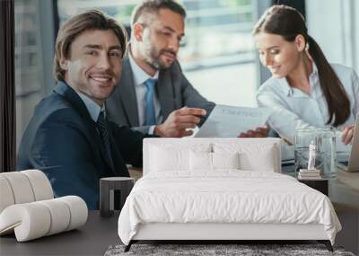 handsome businessman looking at camera during meeting at modern office Wall mural