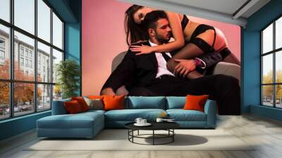 handsome businessman sitting on armchair with sexy girl in lingerie Wall mural