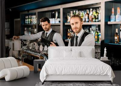 Handsome male bartenders working in bar Wall mural