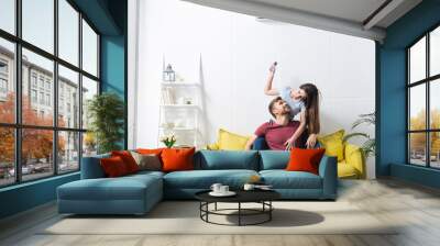 happy emotional couple hugging at home with air conditioner Wall mural