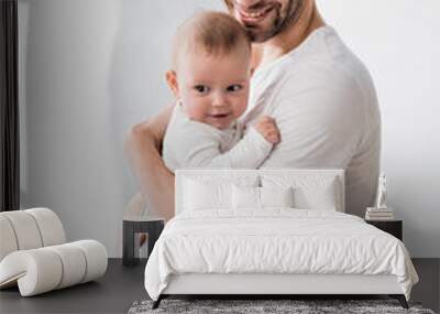 happy father holding in arms cheerful baby boy Wall mural