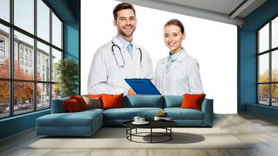 happy female doctor holding clipboard while her male colleague standing near isolated on white Wall mural