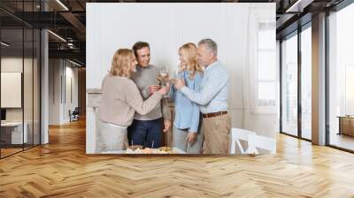 happy friends cheering while standing against table Wall mural