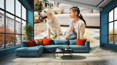 happy girl in casual attire playing doctor with labrador in modern living room, toy first aid kit Wall mural