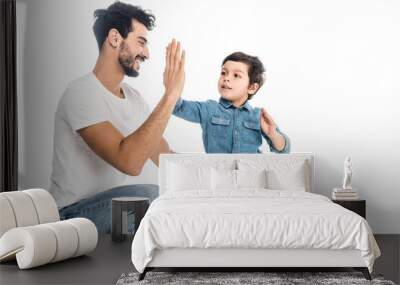 happy hispanic man giving high five to smiling son isolated on white, two generations of men Wall mural