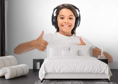 happy kid listening music in headphones and showing thumbs up isolated on white Wall mural