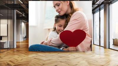 happy mother and daughter with red heart symbol hugging at home Wall mural