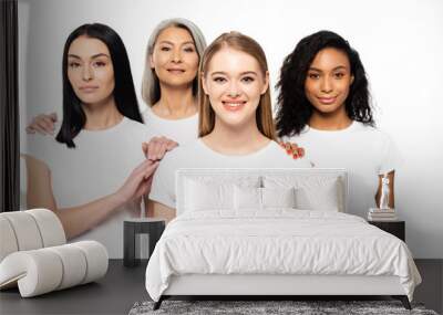 happy multicultural women in white t-shirts looking at camera isolated on white Wall mural