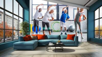 happy multiethnic senior sportspeople synchronous exercising at sports hall Wall mural