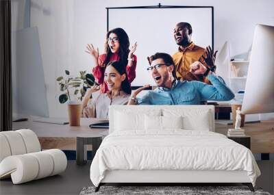 happy multiracial business team working on project together in office Wall mural