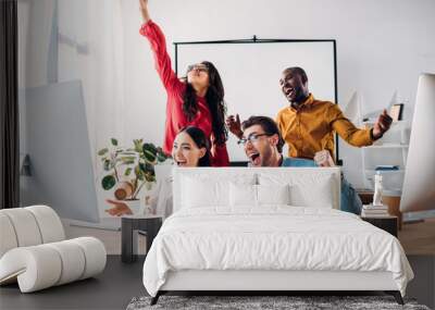 happy multiracial business team working on project together in office Wall mural