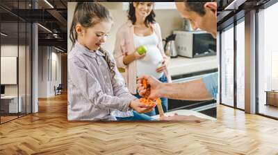 happy smiling family making salad together at kitchen Wall mural