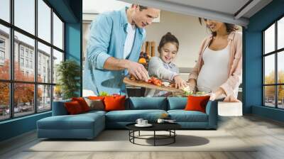 happy smiling family making salad together at kitchen Wall mural