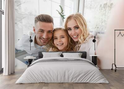 happy young family taking selfie in cafe Wall mural