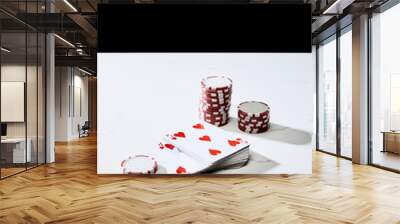 high angle view of casino chips near deck of cards on white surface isolated on black Wall mural