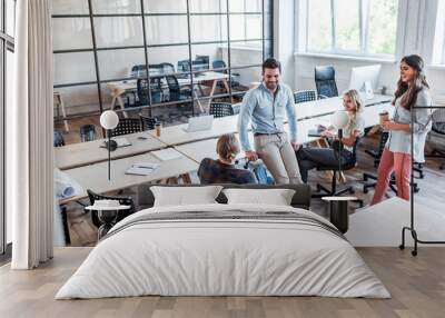 high angle view of happy young business people talking at workplace Wall mural