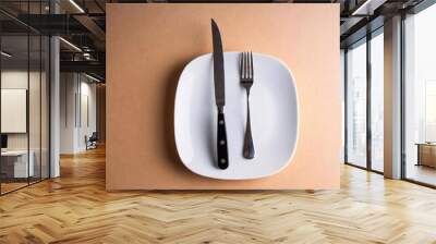 knife on the table with a white plate and a knife. Wall mural