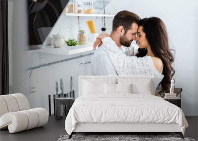 lovely gently couple embracing with closed eyes at kitchen Wall mural