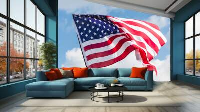 low angle view of stars and stripes on american flag against blue sky Wall mural