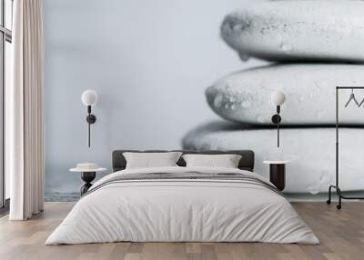 Macro shot of white zen stones in water drops on wet glass isolated on grey Wall mural