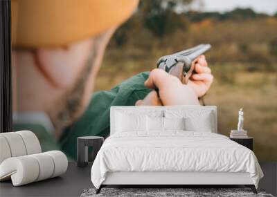 man aiming at something with gun Wall mural