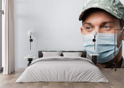 military man in uniform and medical mask looking away isolated on white, banner Wall mural