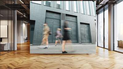 motion blur of people walking on street near grey building Wall mural