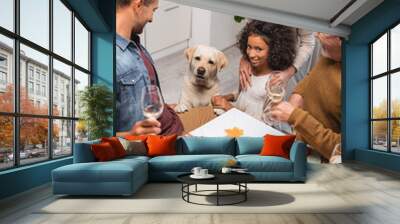 multicultural family and golden retriever near table served with festive thanksgiving dinner Wall mural