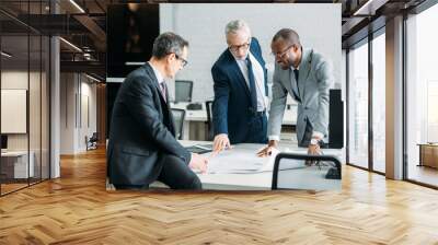 multiethnic businessmen discussing new business strategy on meeting in office Wall mural