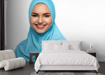 Muslim woman in hijab smiling at camera isolated on white Wall mural