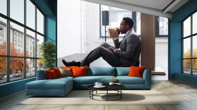 nervous african american speaker breathing with paper bag and having panic attack during business conference in office Wall mural