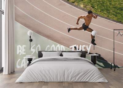 overhead view of mixed race sportsman running at stadium with be so good they cant ignore you lettering Wall mural