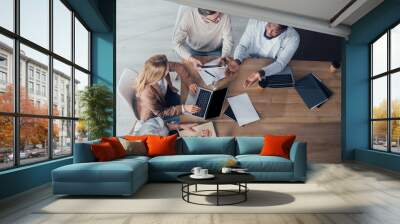 overhead view of multicultural colleagues talking and sitting at table during meeting Wall mural