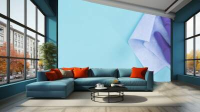 panoramic shot of cleaner in purple rubber glove holding rag on blue background Wall mural