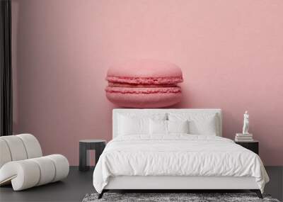 Pink French macaroon in center on pink background Wall mural