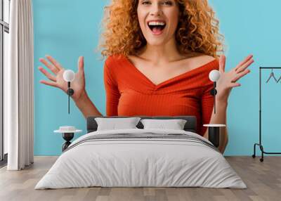 portrait of beautiful excited woman isolated on blue Wall mural