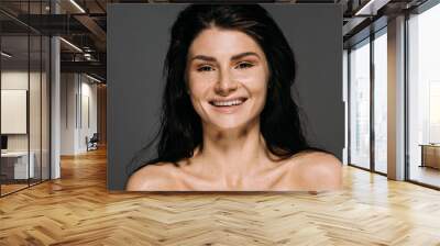 Portrait of happy emotional girl with freckles on face isolated on grey Wall mural