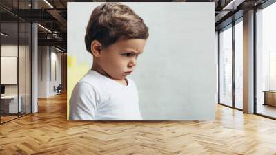 portrait of little offended boy in bad mood at home Wall mural