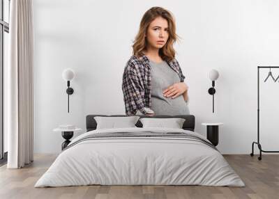 portrait of sad pregnant woman in casual clothing isolated on grey Wall mural