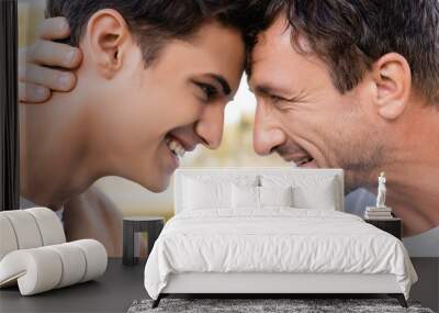 profile of joyful father and teenager son looking at each other Wall mural