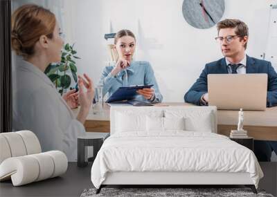 recruiters looking at employee talking on job interview Wall mural