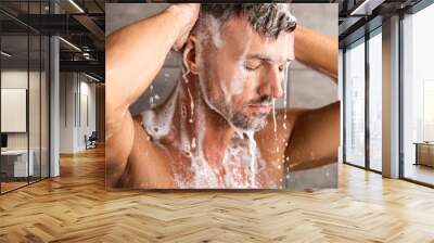 selective focus of adult man with closed eyes washing foam in shower Wall mural