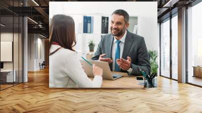 selective focus of advisor sitting at table with laptop and woman in office Wall mural