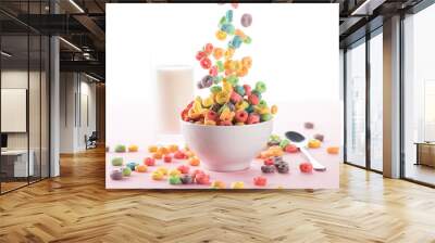 selective focus of bright multicolored breakfast cereal falling in bowl near milk and spoon on white background Wall mural