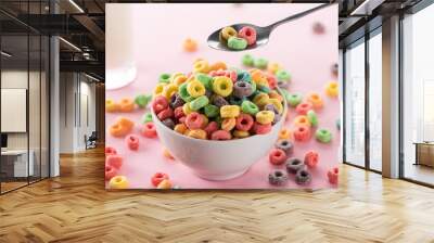 selective focus of bright multicolored breakfast cereal in bowl near glass of milk and spoon on pink background Wall mural