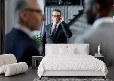 selective focus of businessman talking on smartphone in office Wall mural