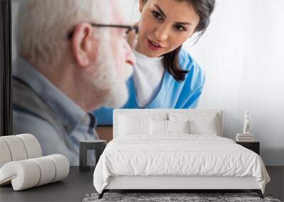 Selective focus of calm nurse talking to elderly patient Wall mural