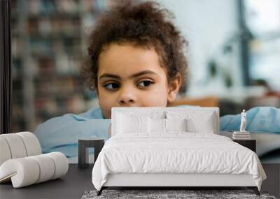 selective focus of happy african american kid near book on table Wall mural