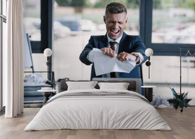 selective focus of irritated man screaming while tearing paper near disposable cup Wall mural