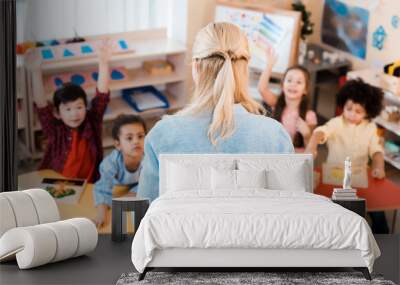 Selective focus of teacher conducting lesson with kids in montessori school Wall mural